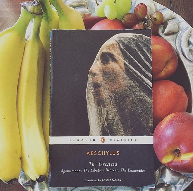 Penguin Classics edition of The Oresteia, by Aeschylus, laying in a bowl of fruit.